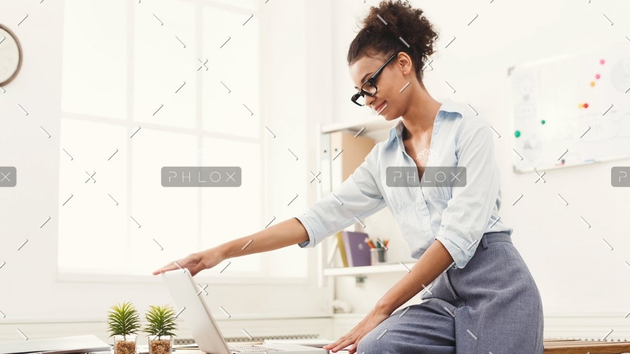 demo-attachment-184-business-woman-opening-laptop-at-office-PU4ZAGW
